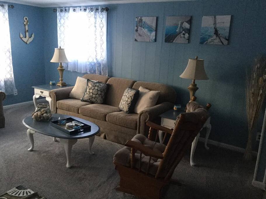 Freshly redecorated living room with cool tones and nautical decor