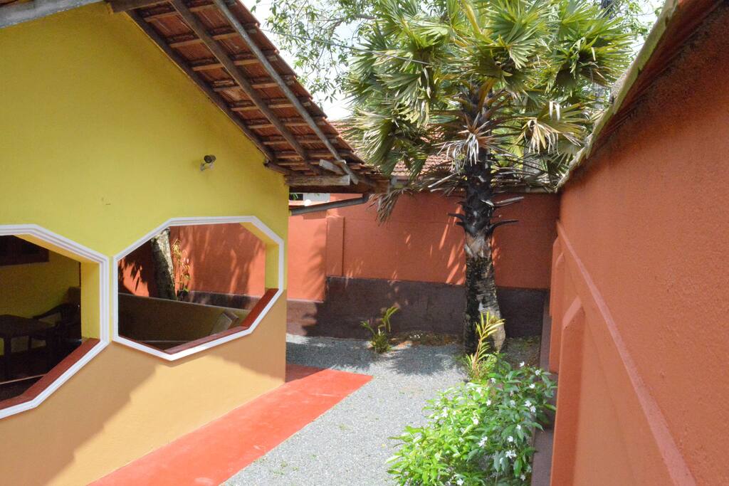 Just inside between the house and wall.