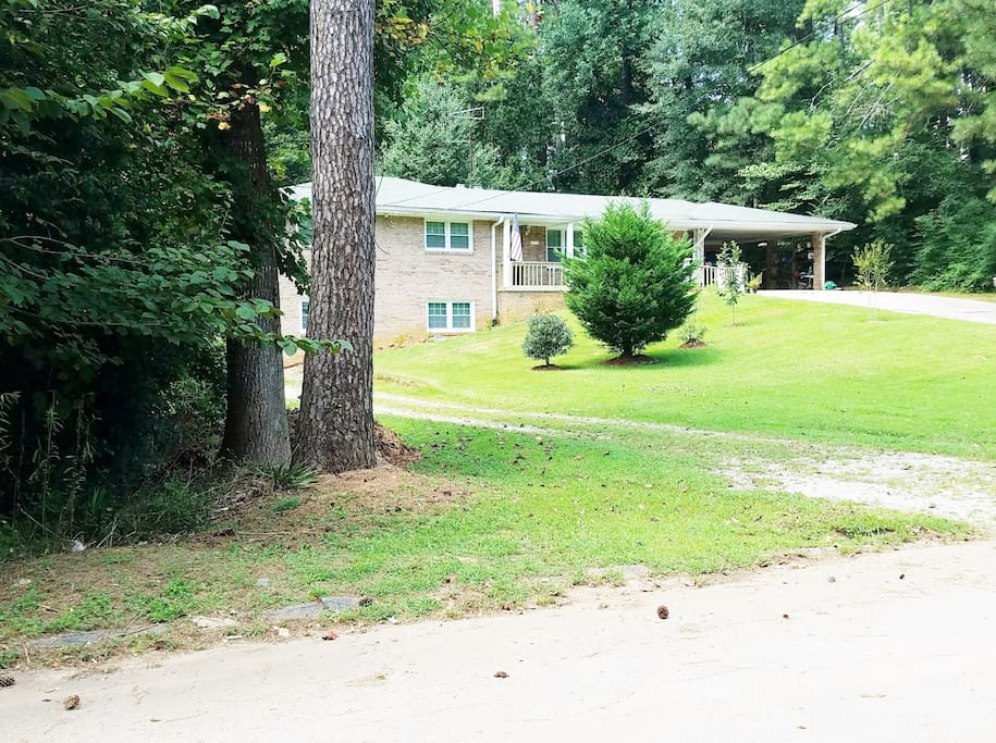Look for gravel drive just past the wooded lot on the corner.