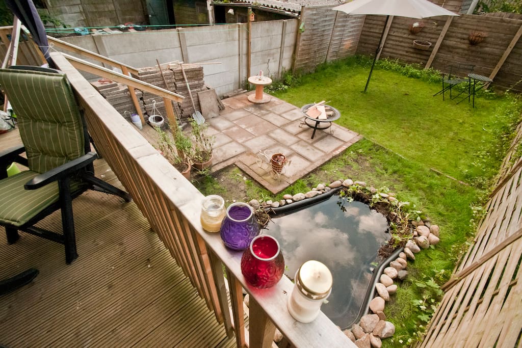 Big garden with a roofed veranda, a cute pond with fish, cosy firepit and enough seating areas.
