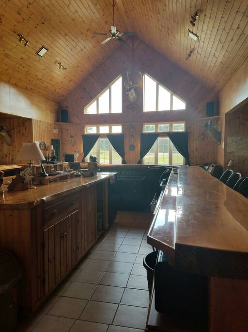 From behind the bar looking out the windows in front of lodge.