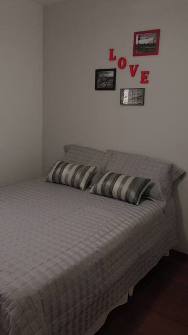 This bedroom has a wall mounted TV with acess to Netflix