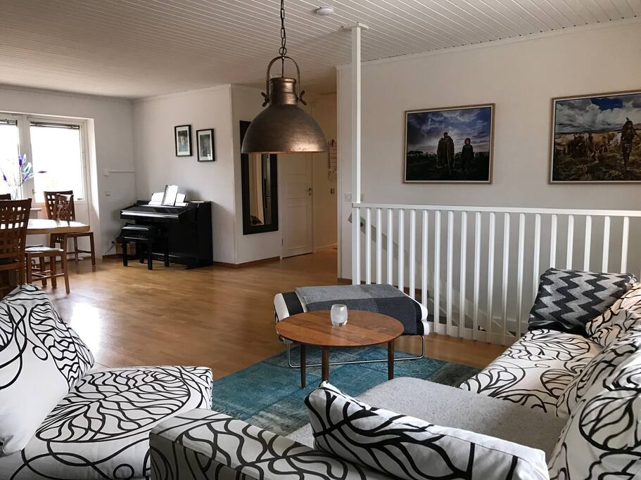 Social area with sofas, piano and a fireplace. With access to the patio.