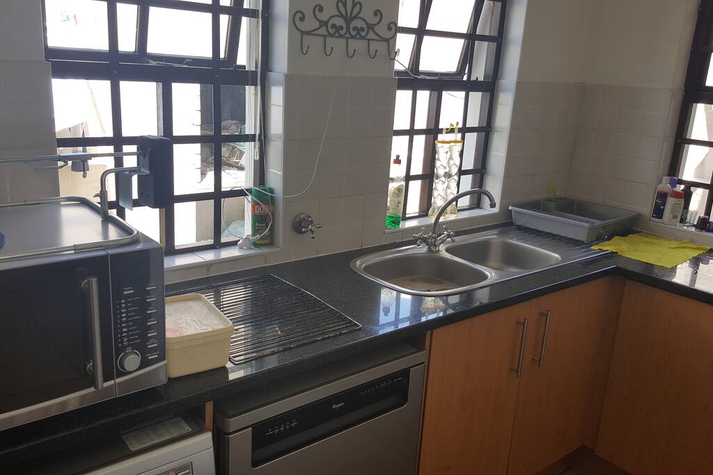 Wash-up area which also includes washing machine, dish washer and tumble dryer.
