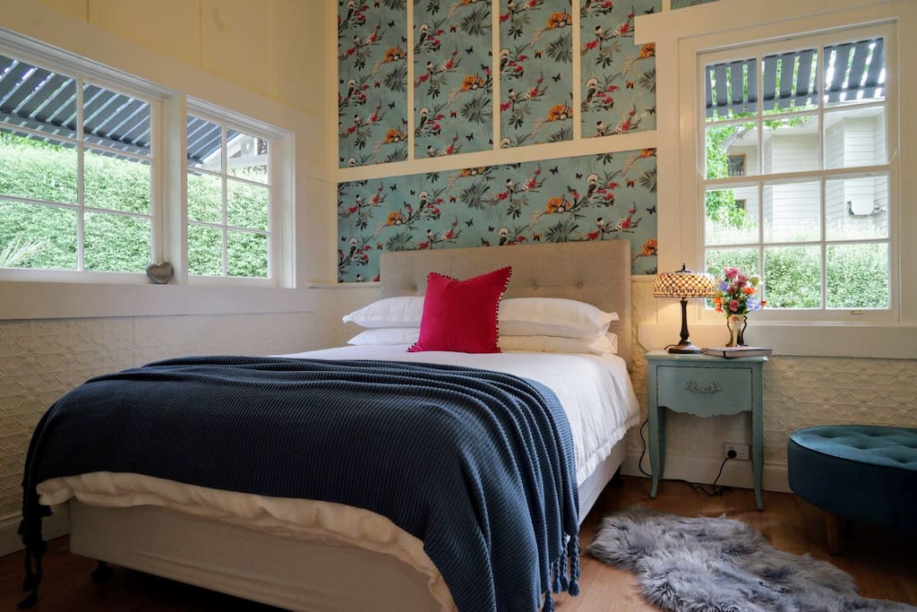 Light filled bedroom with queen bed