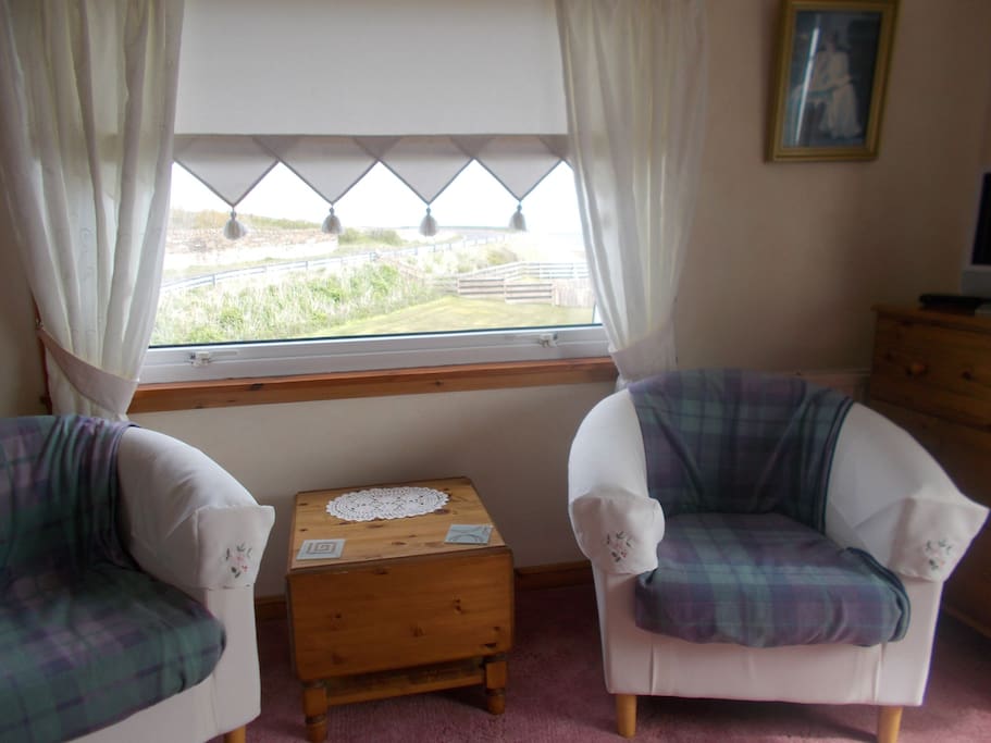 en suite bedroom seating and tv.