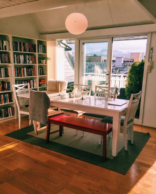The dining table can fit 10 people. West facing veranda in the background