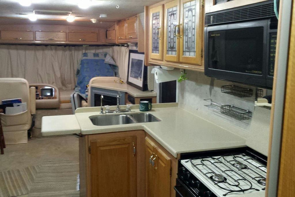 Gas stove, side by side refrigerator, filtered water in sink, and plenty of cabinet space, microwave and oven.