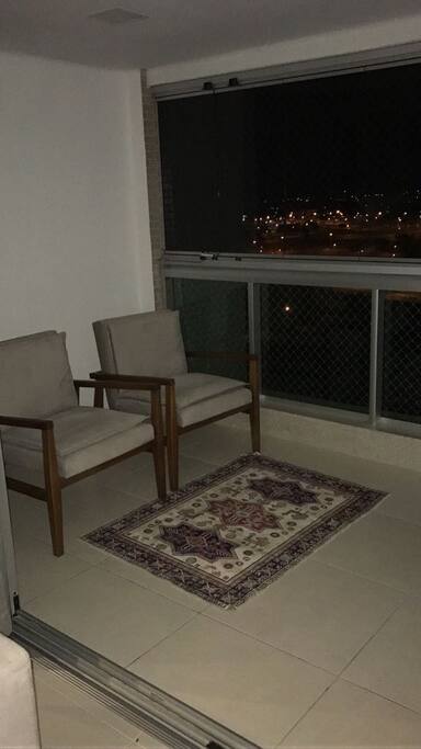 Um espaço confortável para passar alguns momentos na varanda.