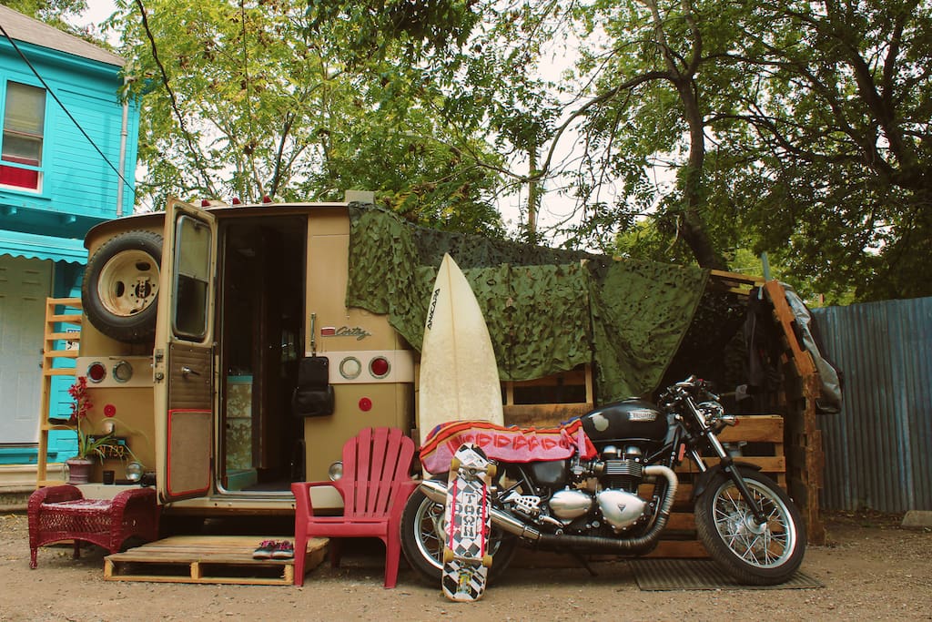 Large bivouac hang area on the side - desk, faux grass floor, fridge, chairs.