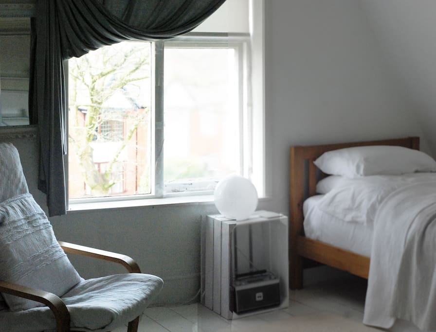 Front attic room overlooking mature trees in the garden and street below
