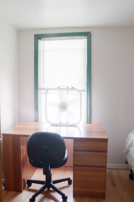 desk space with window facing north and desk lamp to the left (not visible)