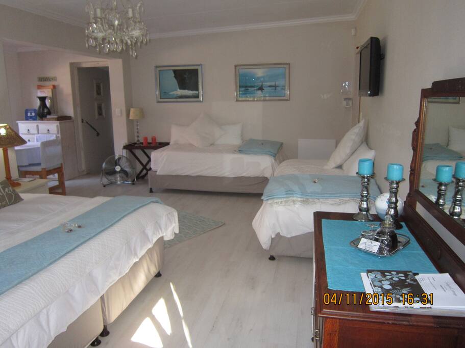 Open plan room with king bed and 2 single beds