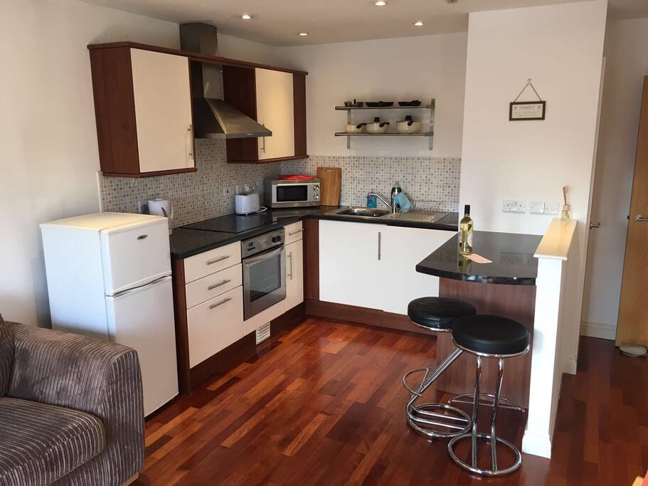 Kitchen with fridge/freezer, cooker/hob and washing machine.