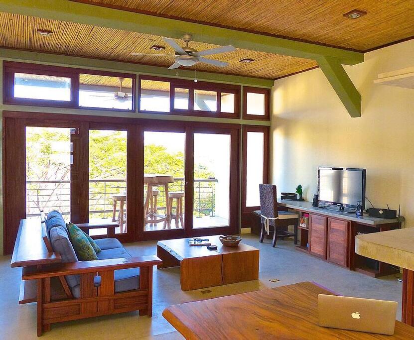 Only the good stuff. Simplemente Madera furniture completes the custom built ins for a great open concept space. Double sliding glass doors on both ends of the floor with screens blends the outside living in.