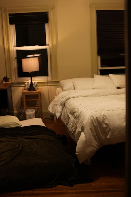 View of bed and full futon on the floor (for party of 2 or more)