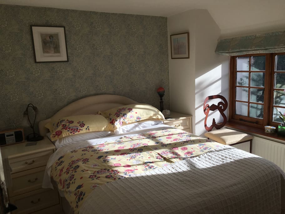 Large comfy bed with bedside table and lamp