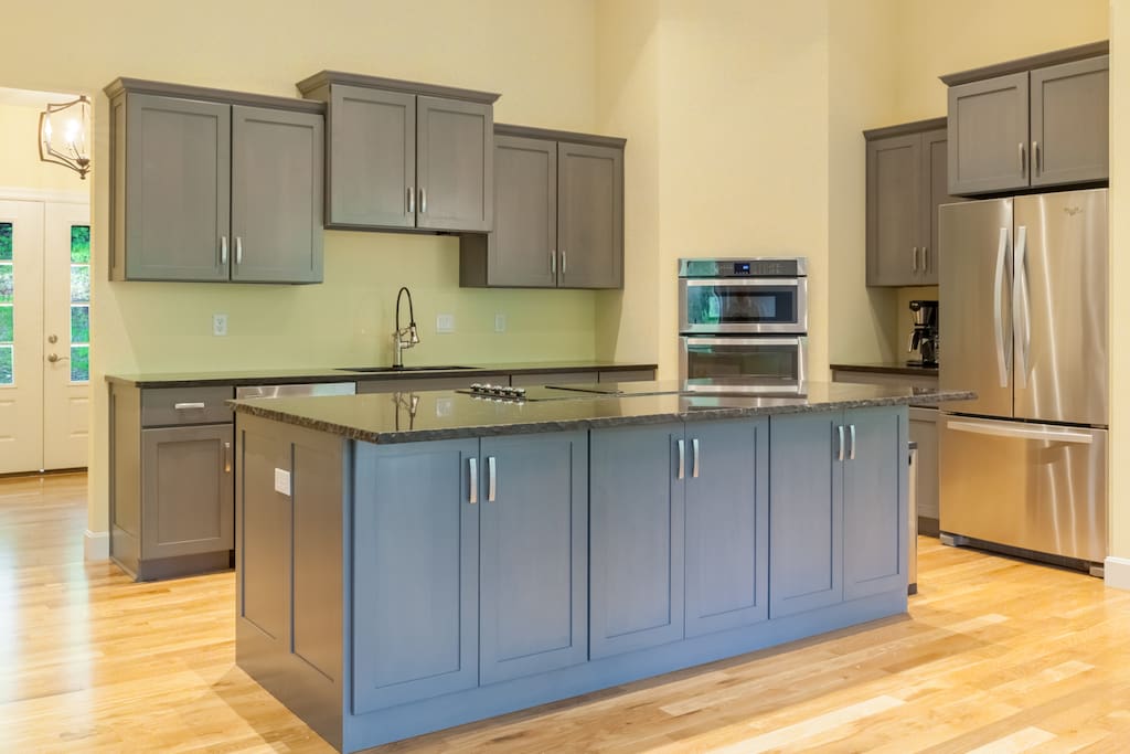 An open kitchen with brand new appliances and cookware