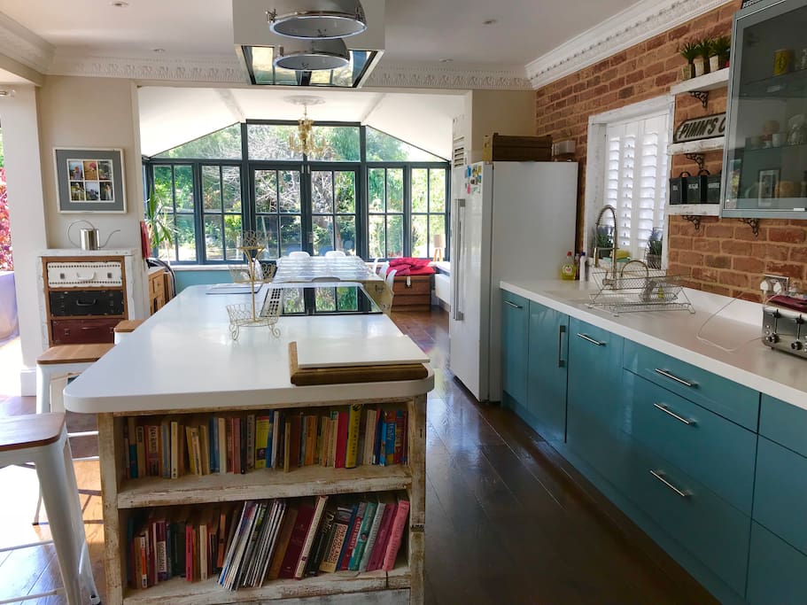 The exposed brick just renovated kitchen dinner with a large table, American fridge-freezer and two sets of double doors that lead onto the decking and private walled garden.