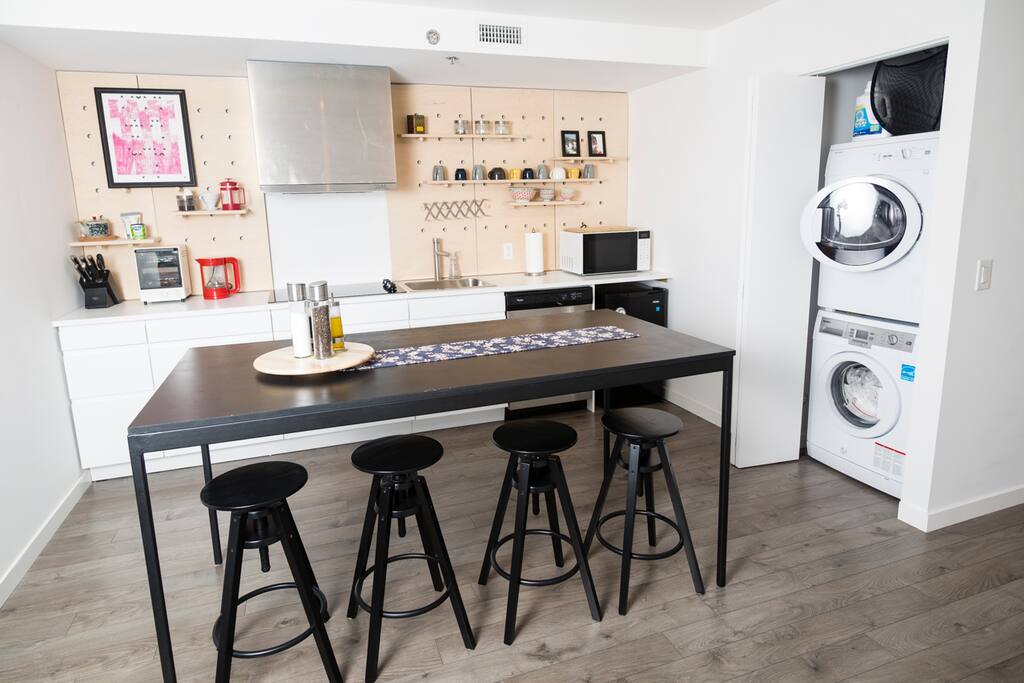 Kitchen with microwave, mini fridge, dish washer, stove top, toaster oven, dishes, cutlery, coffee, and more!