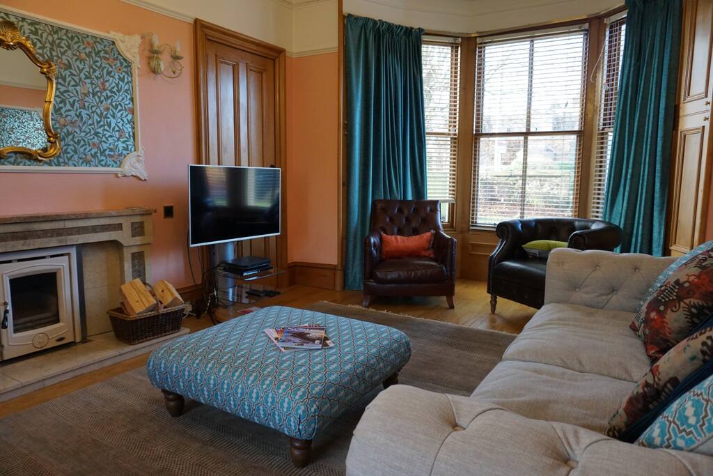 The sitting room has comfortable seating for 8, a wood-burning fire and Sky TV.