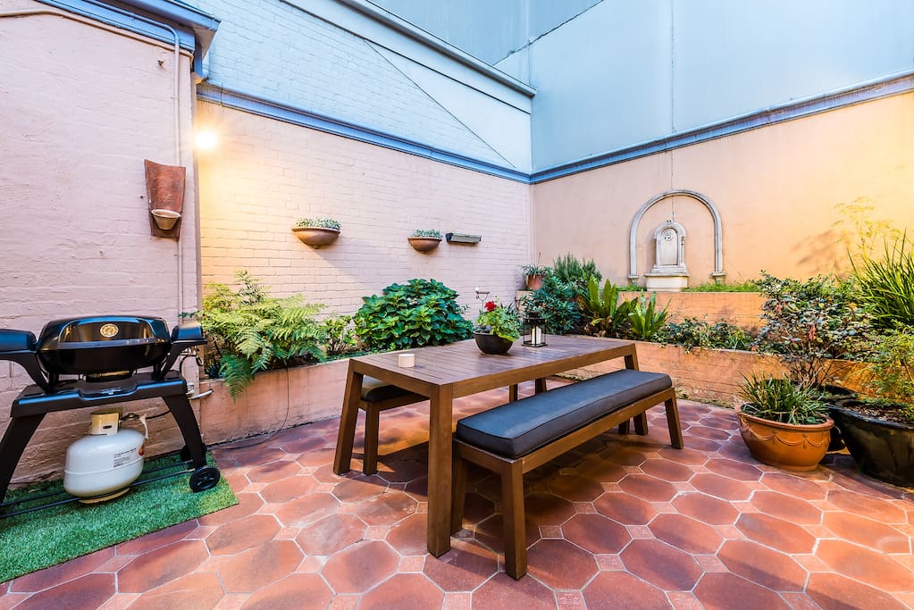 Large outdoor table with BBQ. Ideal to enjoy meals or drinks outside