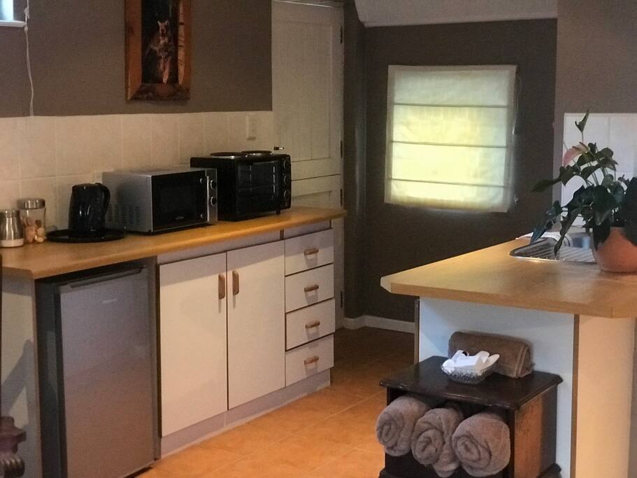 Main Bedroom Kitchen consists of cutlery, crockery, a mini fridge, kettle, microwave, coffee, tea, sugar, toaster and a mini oven with two solid hot plates.