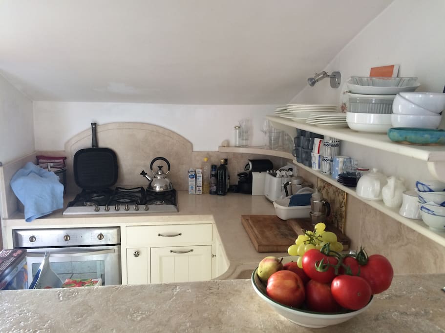 kitchen with full oven, hob, fridge, dishwasher, toaster, Nespresso machine.