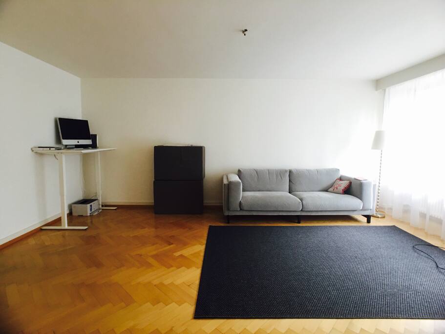 Living room. IMac in corner is available for use. Guests 3 and 4 can sleep on two mattresses on the floor and guest 5 on the couch.