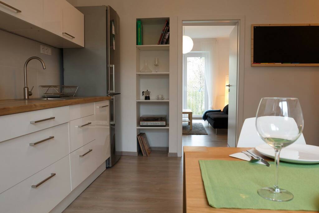 Modern and well furnished kitchen with large dining table.