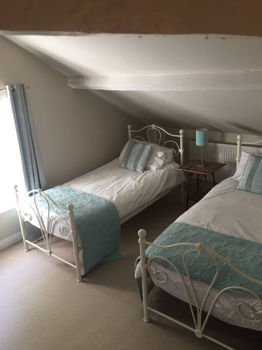 Twin bedroom with en-suite washhandbasin and WC