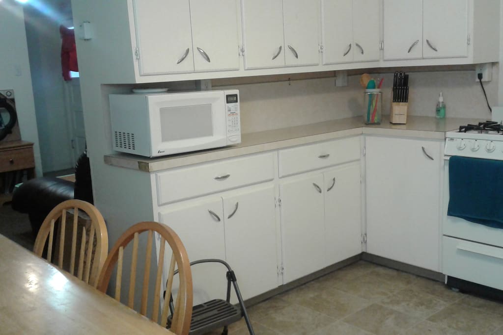 Shared kitchen area with available appliances and utensils.