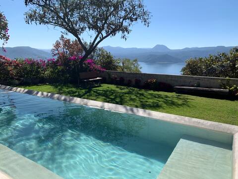 House nestled in the mountain and beautiful lake view
