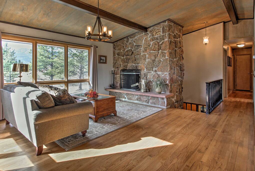 Enjoy a good book or game in front of the large moss rock fireplace.