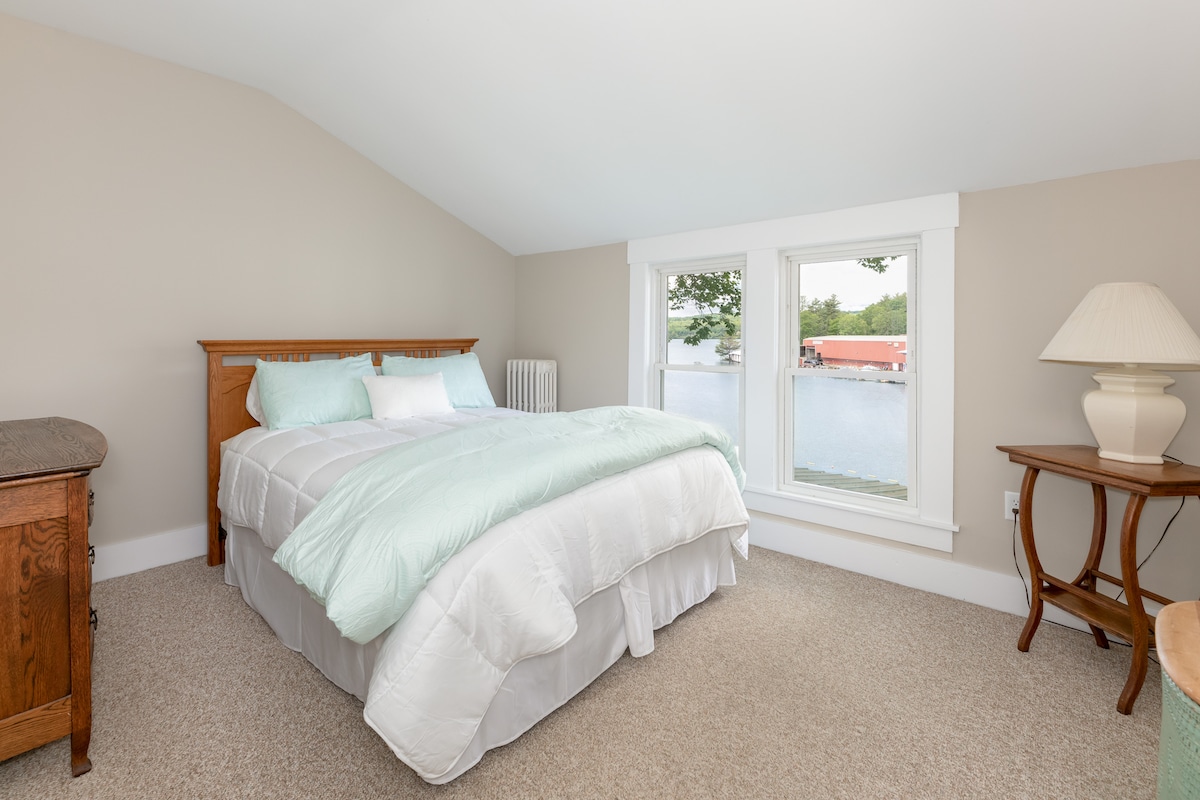 Bedroom 2 with a queen bed and the view out to the lake