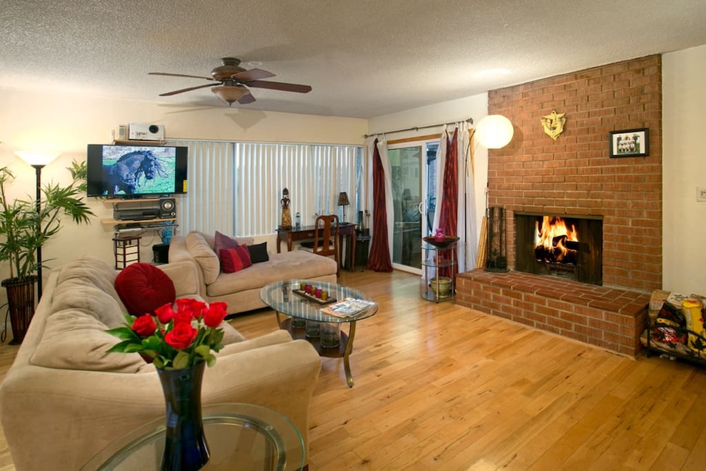 Spacious open living space with a cozy fireplace.