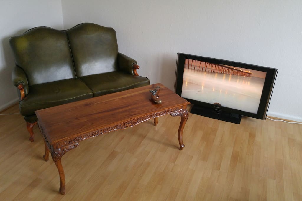 Antique leather couch, antique table and LED TV with FireTV built in, plus high speed WIFI internet.