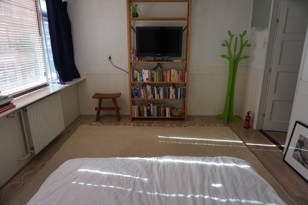 Bedroom with TV and books to borrow