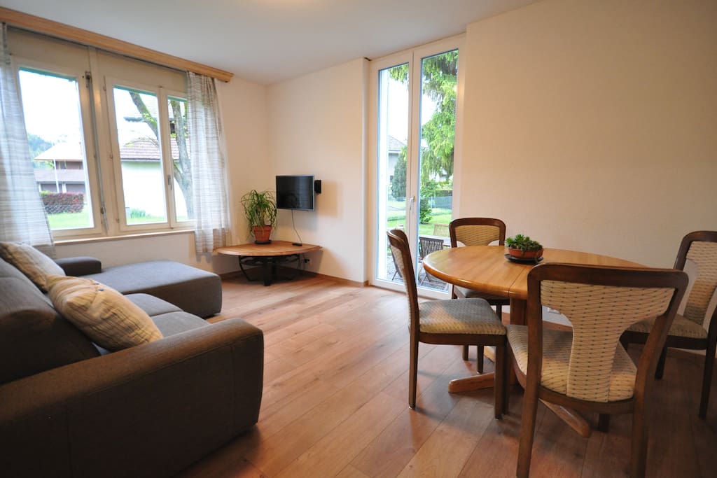 Comfortable sofa and dining for 4. Doors leading onto garden.