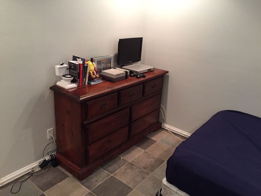 The dresser. TV has no cable but DVD player is connected. Nintendo works some of the time.