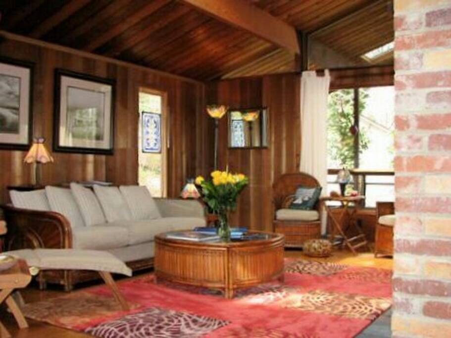 Living room opens to dining area and vaulted windows that have a vast view of soaring eagles, feeding birds and park