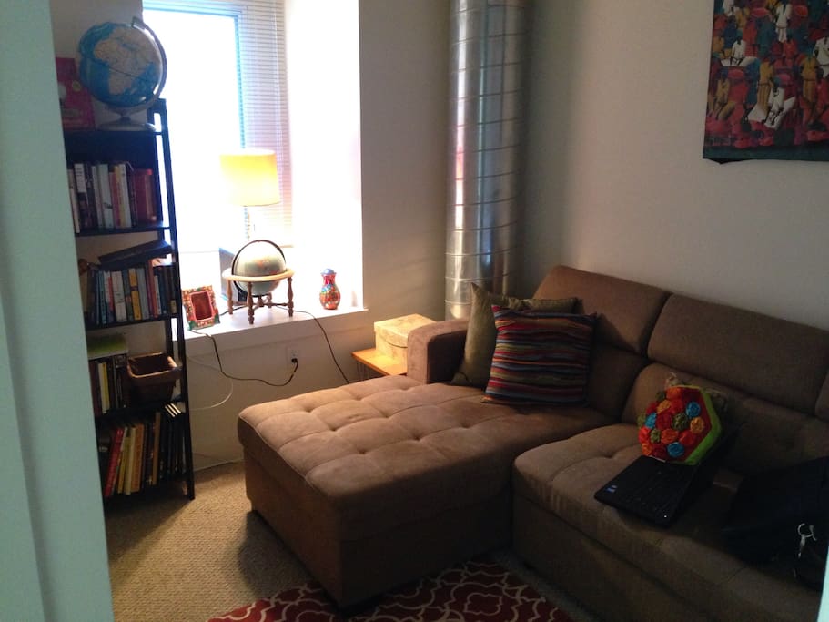 Den with couch that transforms into a queen-sized sleeper for a third guest.