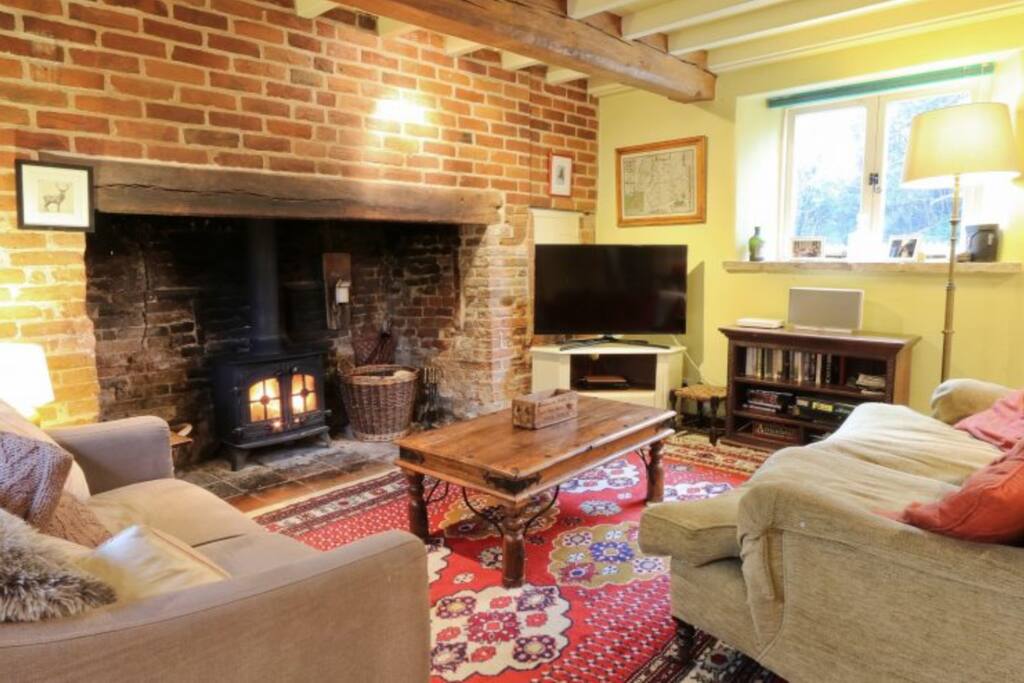 Cosy sitting room, large inglenook fireplace with wood burning stove