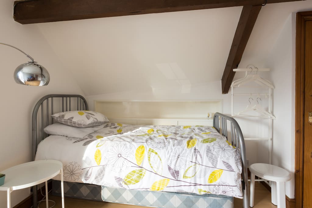 Large single bedroom on 2nd Floor showing hanging space, bedside table and lamp