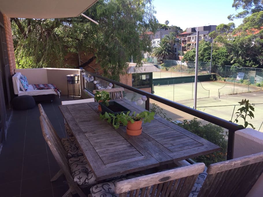 Wrap around balcony with day bed, dining area and BBQ