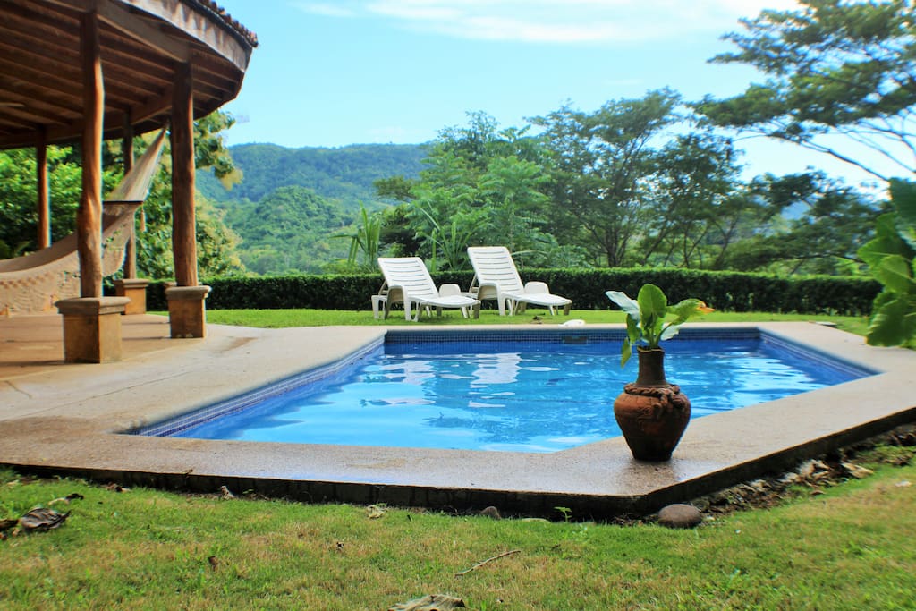 Chill in the pool with a cool drink and watch Scarlet macaws fly by.