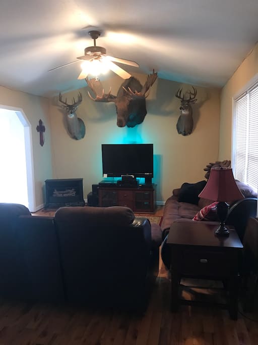 Our comfortable living room will sit 5. Four of the seats will recline. You can lay back and enjoy watching satellite tv (or just stare at the moose).