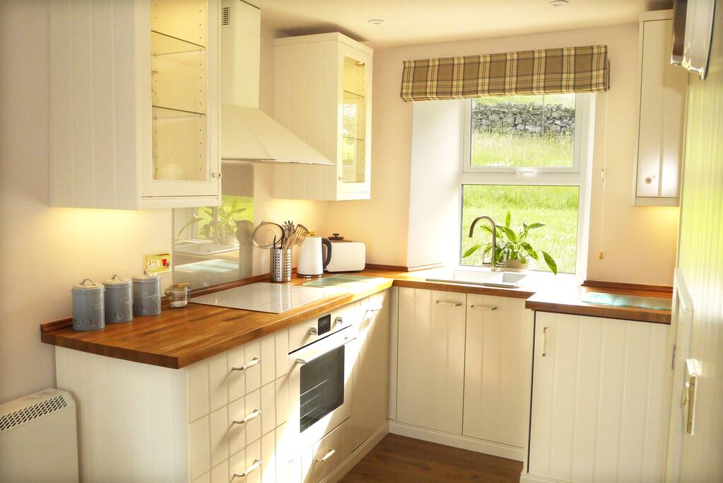 Kitchen with fridge freezer, washer/dryer and dishwasher.
