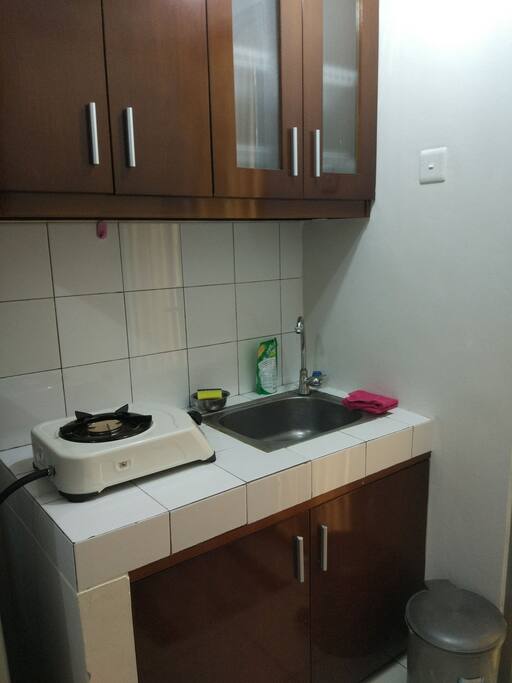 Kitchen with stove and electric kettle for hot water