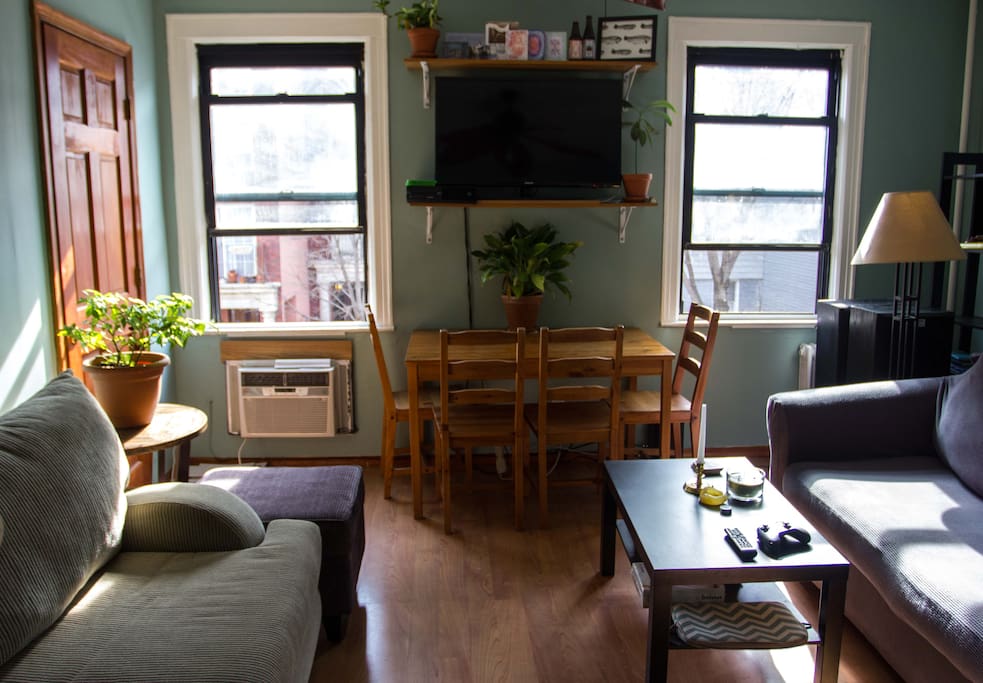 The living room is quite massive, and comes fully furnished with two couches, coffee table, ottoman, end shelves, and an elegant pine dining table with four chairs.